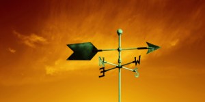 copper weather vane with colorful sunset sky, panoramic frame